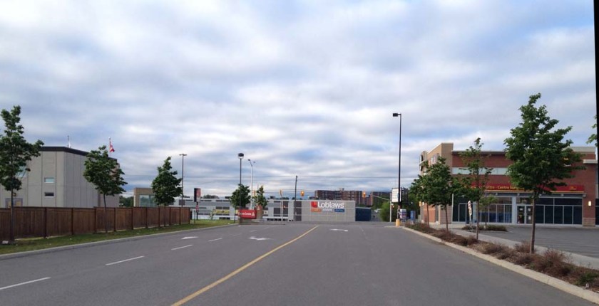 Riding along mall entrance towards traffic lights across Baseline