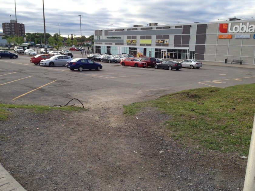 Well trodden desire line path to the Loblaw's parking lot.