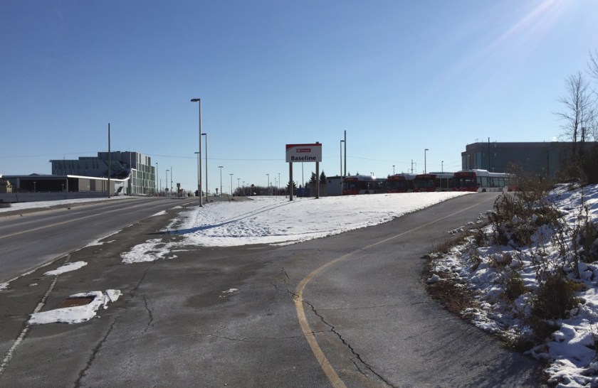 On the left - sidewalk in front of transit stop. On the left - path around the transit stop.